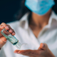 Young woman disinfecting her hands using hand sanitizer gel.